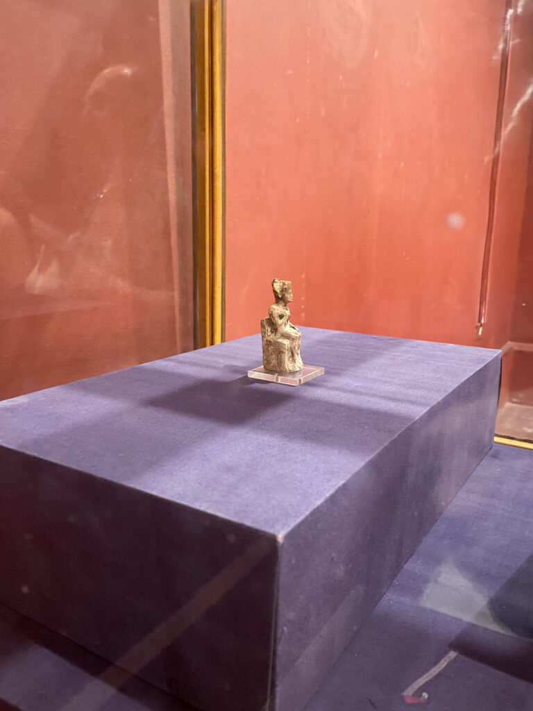 a small statue of king khufu seated