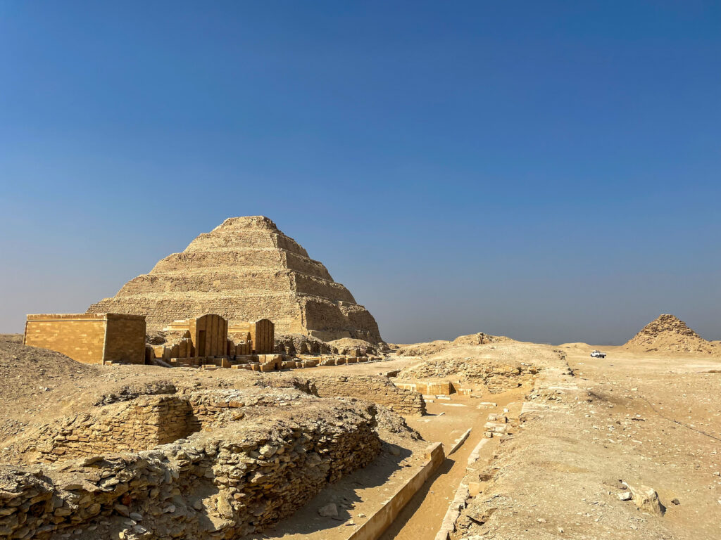 Step Pyramid behind ruins of ancient Egypt